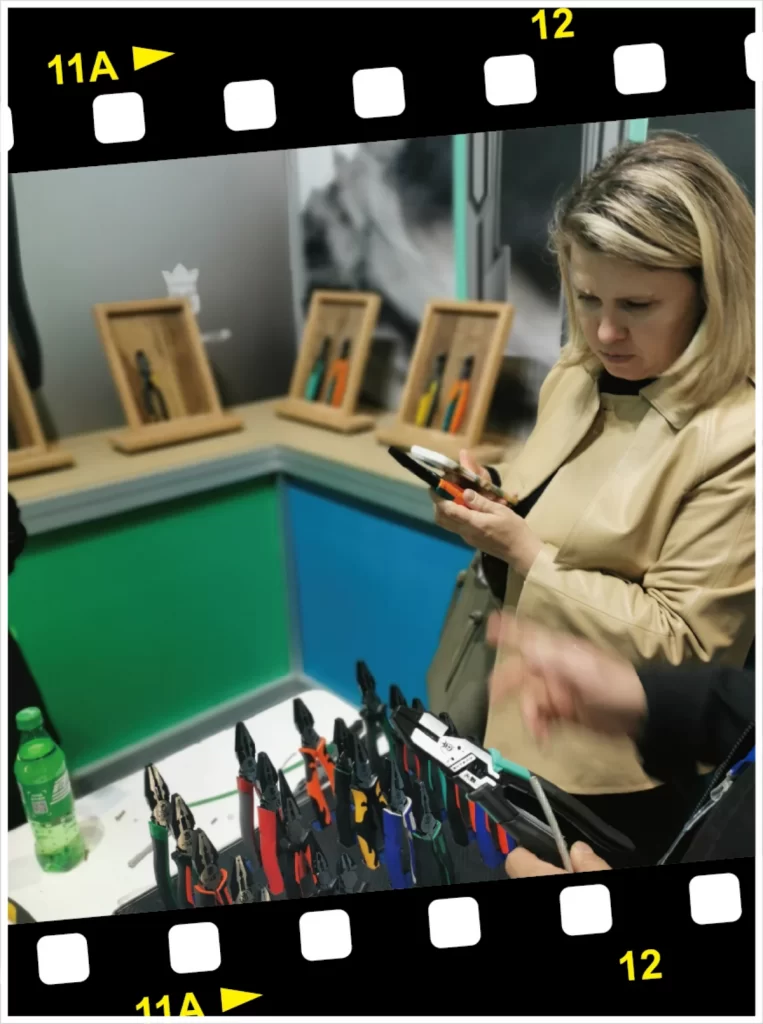 a woman checking the heavy duty pliers at hardware hand tools exhibition